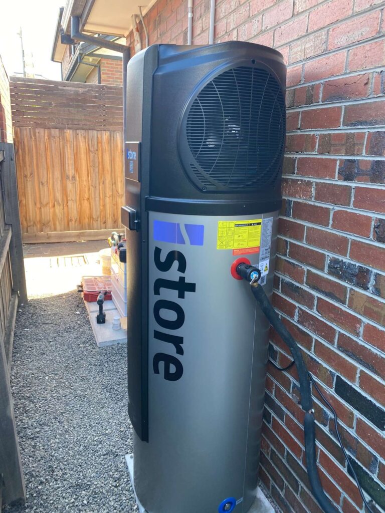 iStore heat pump hot water unit newly installed in a side passage